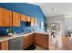 Kitchen featuring wood cabinets, tile countertops, stainless steel appliances, and a vaulted ceiling at 22580 E Ontario Dr # 204, Aurora, CO 80016