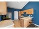 Functional kitchen featuring wood cabinets, stainless steel appliances, tile countertops, and an open design at 22580 E Ontario Dr # 204, Aurora, CO 80016
