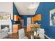 Modern kitchen with blue walls, wooden cabinets, a fireplace, and dining area at 22580 E Ontario Dr # 204, Aurora, CO 80016