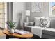 Cozy living room with a comfortable gray sofa, modern art, and bright natural light at 22580 E Ontario Dr # 204, Aurora, CO 80016