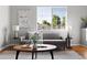 Bright living room with a stylish sofa, modern art, and a large window with natural light at 22580 E Ontario Dr # 204, Aurora, CO 80016