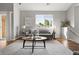 Open living room with a gray sofa, large window, and stylish round coffee table at 22580 E Ontario Dr # 204, Aurora, CO 80016