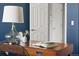 Close-up of desk with lamp, flowers, and book in a stylish and well-lit home office at 22580 E Ontario Dr # 204, Aurora, CO 80016