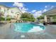Community pool surrounded by lounge chairs, manicured landscaping, and shade structures at 22580 E Ontario Dr # 204, Aurora, CO 80016