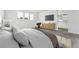 Stylish bedroom showcasing a sitting area, television, and en-suite bathroom access at 3295 N Coolidge Way, Aurora, CO 80019
