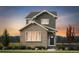 Charming two-story home with a stone facade and vertical siding, surrounded by a well-manicured lawn at 3295 N Coolidge Way, Aurora, CO 80019