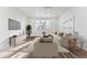 Inviting living room featuring a comfortable sofa, large windows, and stylish furnishings at 3295 N Coolidge Way, Aurora, CO 80019