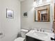 Bathroom featuring a sleek vanity, mirror, and artwork at 28272 Shadow Mountain Dr, Conifer, CO 80433