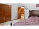Bedroom featuring wood trim, closet, and a cozy bed at 28272 Shadow Mountain Dr, Conifer, CO 80433