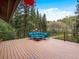 Spacious outdoor deck offering scenic views of mature trees at 28272 Shadow Mountain Dr, Conifer, CO 80433