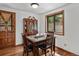 Charming dining room with a marble table and a decorative china cabinet at 28272 Shadow Mountain Dr, Conifer, CO 80433