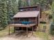 Inviting home with a spacious deck and hot tub, set among towering trees at 28272 Shadow Mountain Dr, Conifer, CO 80433