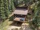 Wonderful aerial view of home featuring a deck perfect for relaxing in the woods at 28272 Shadow Mountain Dr, Conifer, CO 80433