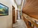 Hallway with wood accents, natural light, and neutral carpet at 28272 Shadow Mountain Dr, Conifer, CO 80433