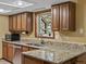 A close-up of a kitchen featuring oak cabinets and beautiful granite countertops at 28272 Shadow Mountain Dr, Conifer, CO 80433