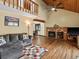 Cozy living room featuring a stone fireplace and high vaulted ceilings at 28272 Shadow Mountain Dr, Conifer, CO 80433