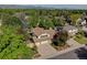 Aerial view of a home with mature trees, attached two-car garage, and a well maintained green lawn at 8043 S Zephyr St, Littleton, CO 80128