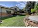 Backyard with a fire pit area, BBQ, patio, green lawn and mature trees providing plenty of shade at 8043 S Zephyr St, Littleton, CO 80128