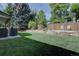 Backyard featuring a fire pit, fence, BBQ, and a grass lawn at 8043 S Zephyr St, Littleton, CO 80128