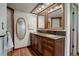 Elegant bathroom with a double sink vanity, decorative mirrors, and luxury fixtures at 8043 S Zephyr St, Littleton, CO 80128