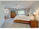 Cozy bedroom with ceiling fan, light-filled window, TV and wooden furniture at 8043 S Zephyr St, Littleton, CO 80128