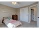 Cozy bedroom with neutral walls, carpeting, closet with slider doors, and a twin bed at 8043 S Zephyr St, Littleton, CO 80128
