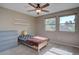 Bedroom featuring a window for natural light, neutral walls, carpet, and shelves for storage at 8043 S Zephyr St, Littleton, CO 80128