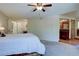 Bright bedroom with an attached bathroom, ceiling fan and warm lighting at 8043 S Zephyr St, Littleton, CO 80128