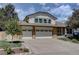 Charming home with a two car garage, and brick facade on the bottom and siding on top at 8043 S Zephyr St, Littleton, CO 80128