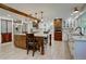 Spacious kitchen with a wooden island, wooden beams, modern appliances, and granite countertops at 8043 S Zephyr St, Littleton, CO 80128