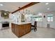 Beautiful kitchen featuring wooden island, granite countertops, stainless steel appliances, and tile backsplash at 8043 S Zephyr St, Littleton, CO 80128