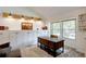 Bright home office featuring a wooden desk, custom cabinetry, and large windows with a view of the neighborhood at 8043 S Zephyr St, Littleton, CO 80128