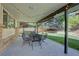 Relaxing covered patio featuring outdoor seating and string lights overlooking the landscaped backyard at 8043 S Zephyr St, Littleton, CO 80128