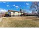 Large backyard featuring a deck and a fenced perimeter at 1231 Missouri Ave, Longmont, CO 80501