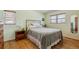 Comfortable bedroom with hardwood floors, light green walls, and a large window at 1231 Missouri Ave, Longmont, CO 80501