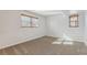 A bedroom featuring neutral carpet, and two windows at 1231 Missouri Ave, Longmont, CO 80501