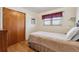 Cozy bedroom with hardwood floors, a closet and a window with a curtain at 1231 Missouri Ave, Longmont, CO 80501