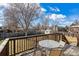 Outdoor deck featuring wood railing and a glass table with chairs at 1231 Missouri Ave, Longmont, CO 80501
