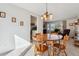 Sunny dining room with wooden table, access to the kitchen, and view of the living room at 1231 Missouri Ave, Longmont, CO 80501