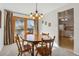Bright dining room with a wooden table and chairs, flowing to the kitchen and back deck at 1231 Missouri Ave, Longmont, CO 80501