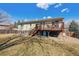 The home's back exterior view showcasing the deck and access stairs at 1231 Missouri Ave, Longmont, CO 80501