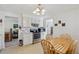 Functional kitchen with white cabinets, stainless appliances, and breakfast table at 1231 Missouri Ave, Longmont, CO 80501