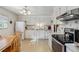 Functional kitchen with white cabinets, appliances, and a cozy breakfast nook at 1231 Missouri Ave, Longmont, CO 80501