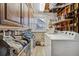 Functional laundry room with storage cabinets, washer, dryer, and hanging rack at 1231 Missouri Ave, Longmont, CO 80501