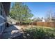 The home has a spacious backyard with a mature tree, patio and wooden deck at 16933 E Bethany Pl, Aurora, CO 80013