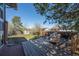 Well-maintained backyard featuring a spacious deck, lush lawn, and mature trees on a sunny day at 16933 E Bethany Pl, Aurora, CO 80013