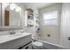 Cozy bathroom features a tub with shower, white vanity, and decorative nautical wallpaper at 16933 E Bethany Pl, Aurora, CO 80013