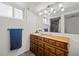 Bathroom with a sink, dresser, track lighting, and a mirror reflecting the shower at 16933 E Bethany Pl, Aurora, CO 80013