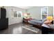 Comfortable bedroom with a single bed, desk, wood laminate flooring, and natural light at 16933 E Bethany Pl, Aurora, CO 80013
