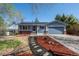 Charming blue home featuring a two-car garage, solar panels, and a beautifully landscaped front yard at 16933 E Bethany Pl, Aurora, CO 80013